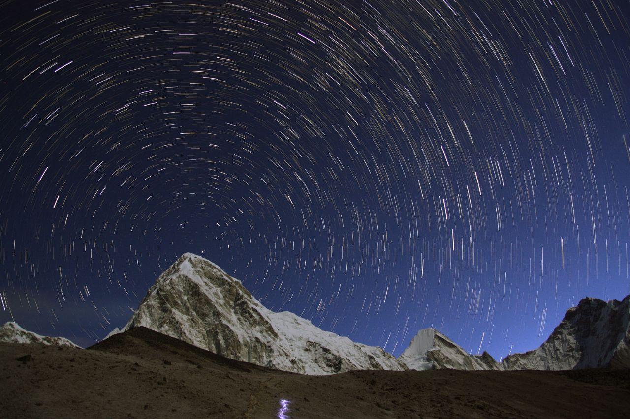 Star trails around the north pole as seen behind Pumori mountain (7161m) from Gorakshep, Nepal (5164m).